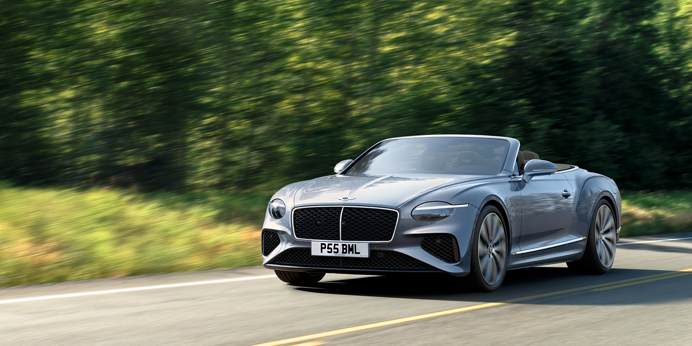 Bentley Taichung New Bentley Continental GTC convertible front view in Silverlake paint with 22 inch ten spoke wheels, driving dynamically on a country road