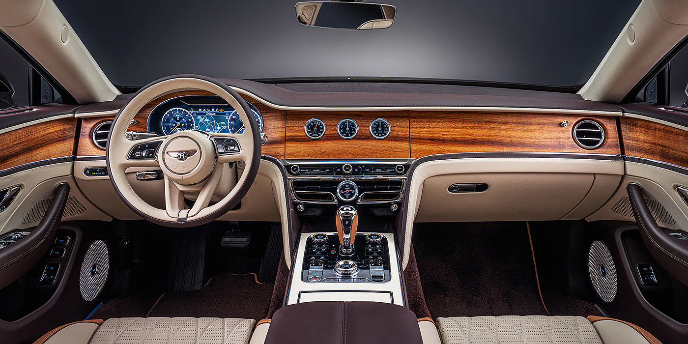 Bentley Taichung Bentley Flying Spur Odyssean sedan front interior in Open Pore Koa veneer with Piano Linen console and Linen and Burnt Oak hides