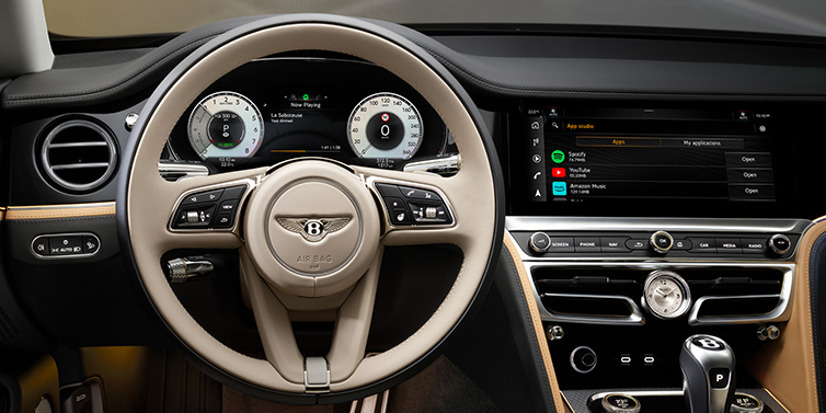 Bentley Taichung Bentley Flying Spur Mulliner sedan front interior detail of steering wheel and driver screens surrounded by Linen and Beluga black hides